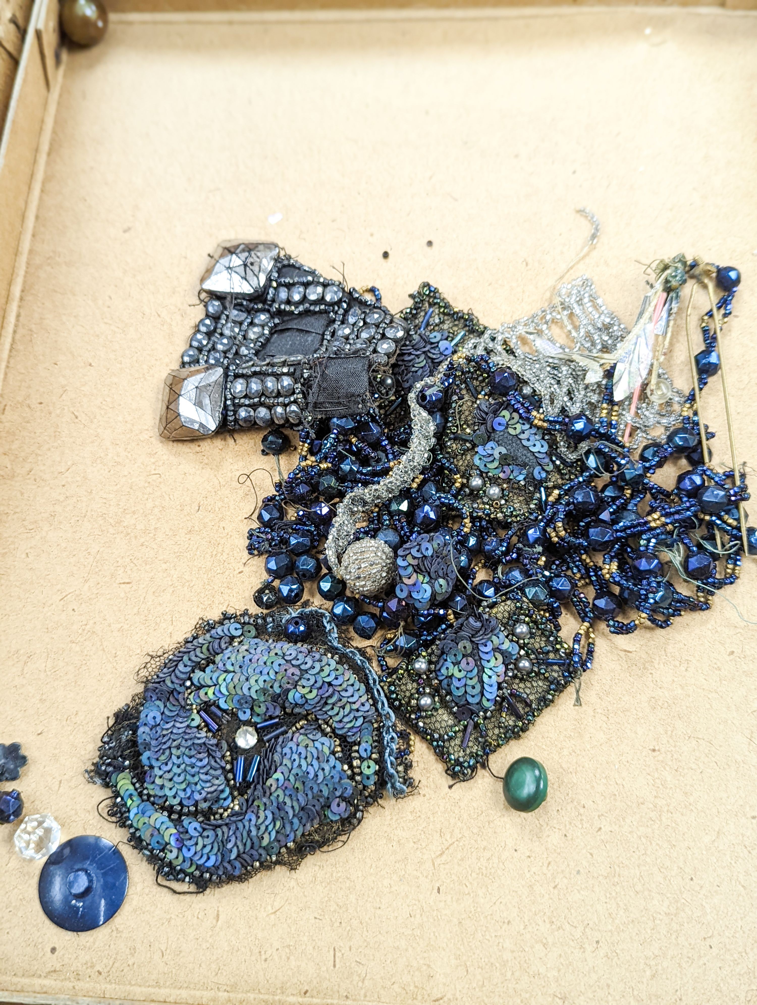 A collection of Edwardian and later sequin and beaded panels on net, a black beaded stole, various buttons etc.